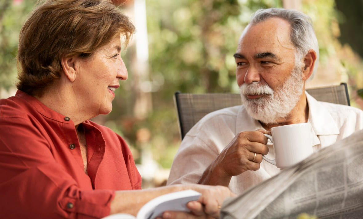 Older couple having a relaxed conversation over coffee