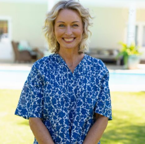 Mature woman standing outdoors in natural light